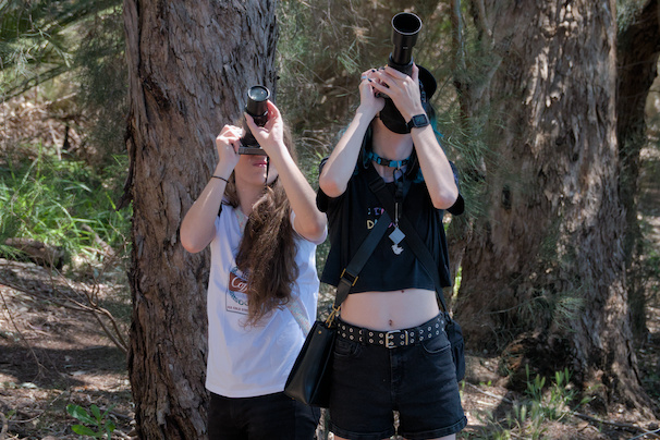 dog and fox both looking through their cameras on a steep upwards angle