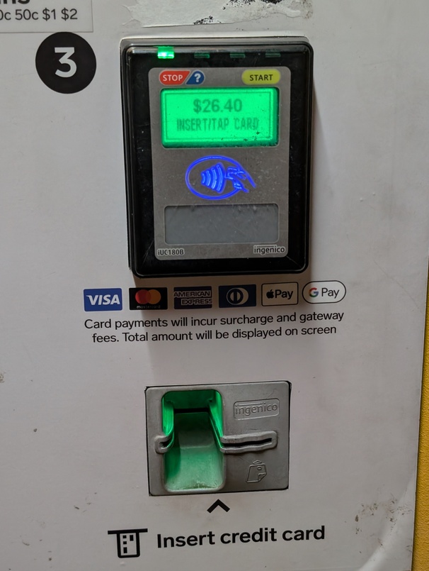 now one of the four lights is lit, and it reads “$26.40”, “INSERT/TAP CARD”