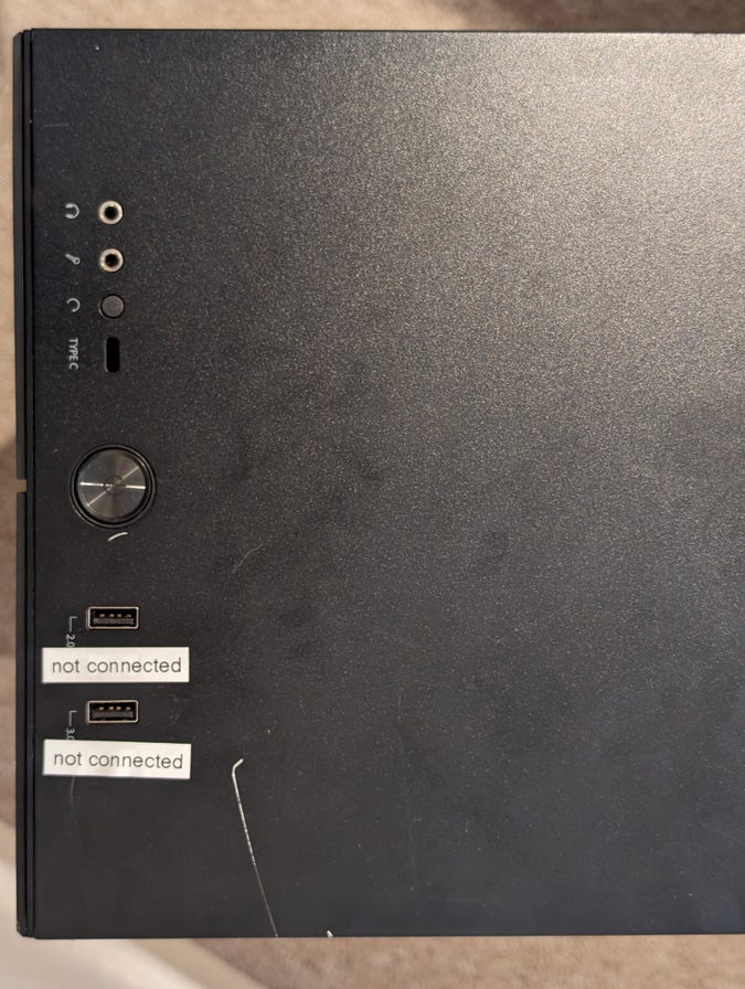 top of computer case, with two of the four usb ports covered by labels that read “not connected”