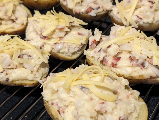 packed into hollowed-out potato halves, grated tasty cheese on top, but we forgot the chives