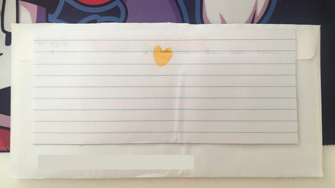 letter on lined paper, folded up and sealed with kapton tape