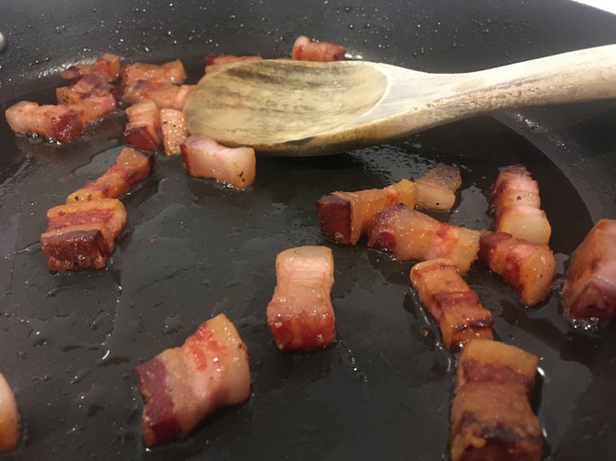 pancetta fried slowly in a cold dry pan, rendering out the fat