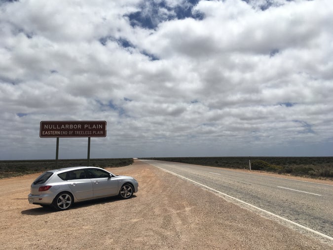 roadside landscape near sign with “NULLARBOR PLAIN” / “EASTERN END OF TREELESS PLAIN” and my pre-drive-by-wire BK mazda3