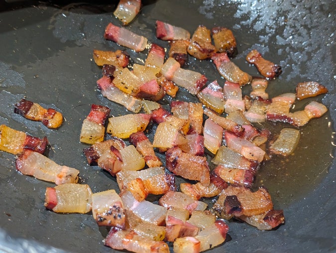 pancetta rendered out and cooked slowly in a wok