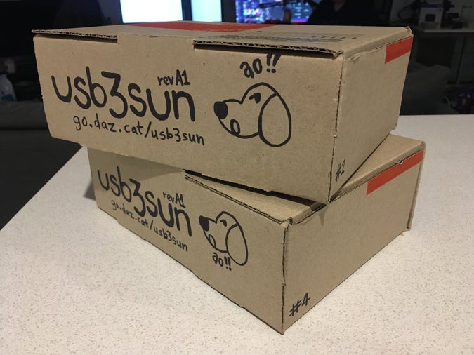 two boxes with “usb3sun rev A1” and a dog saying “ao !!” drawn on the front, numbered #2 and #4