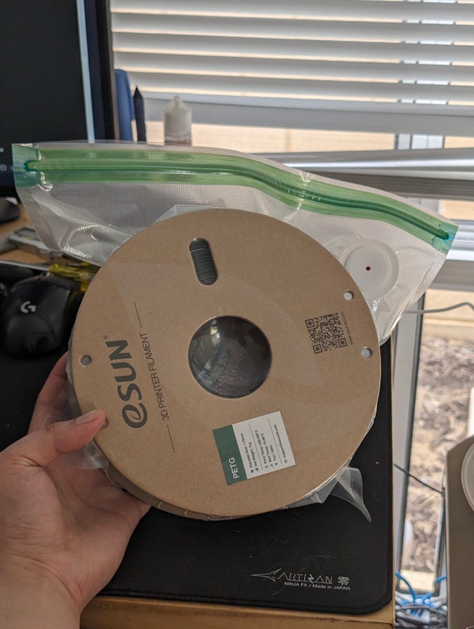 reel of black petg filament, now vacuum sealed in a bag